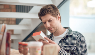 Mann studiert Verpackung Mann studiert Verpackung
